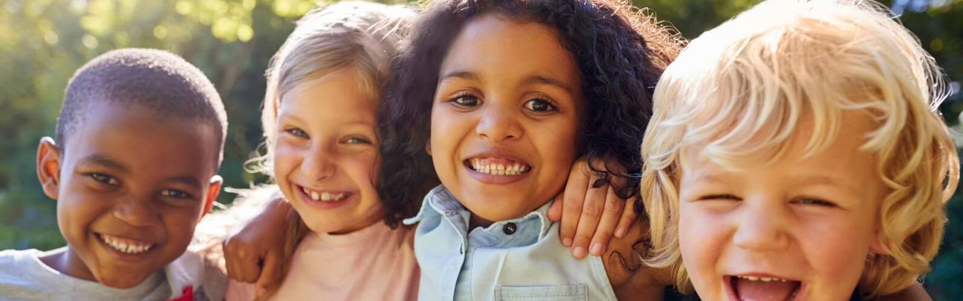 Happy diverse group of children outdoors.